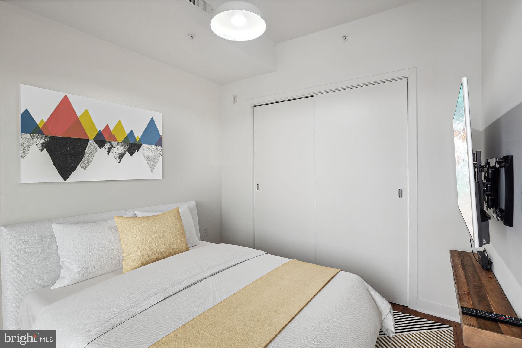 2030 8th Street Northwest, Unit PH5 Washington, DC 20001 - Photo 8 of 20 a bedroom with a bed and a flat screen tv