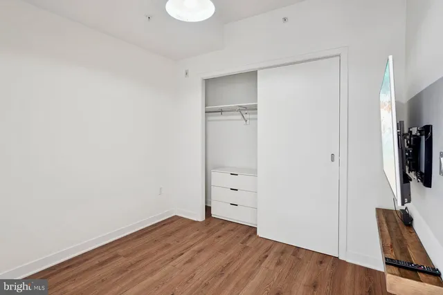 a view of room with wooden floor and a window