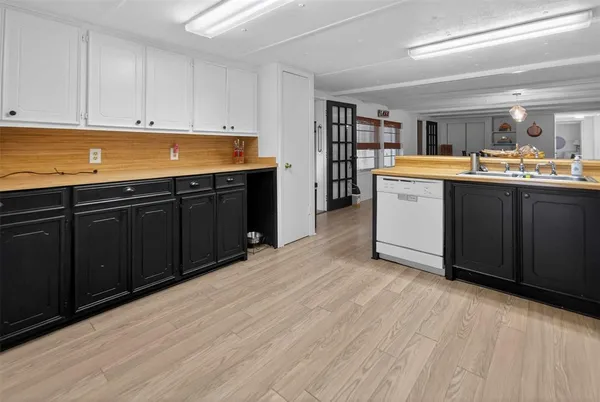 a kitchen with granite countertop a sink and cabinets