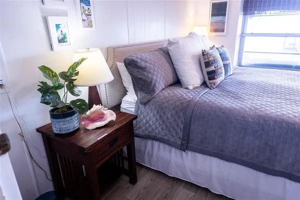 a bedroom with a bed and a potted plant
