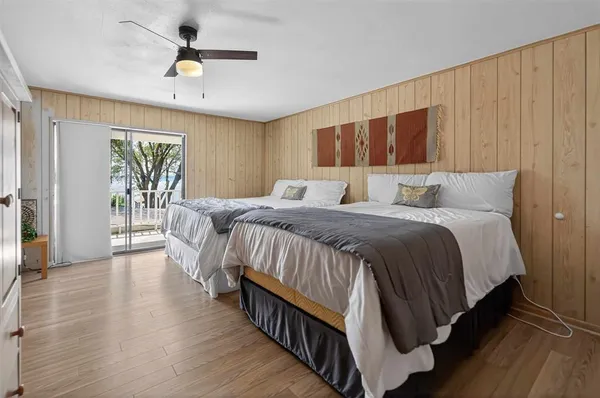a bedroom with a large bed chandelier and a window