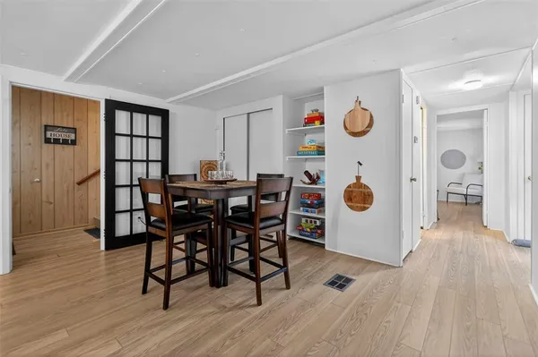 a view of a dining room with furniture and wooden floor