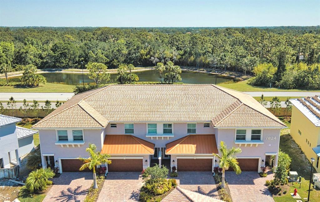 a aerial view of a house with swimming pool and a chairs
