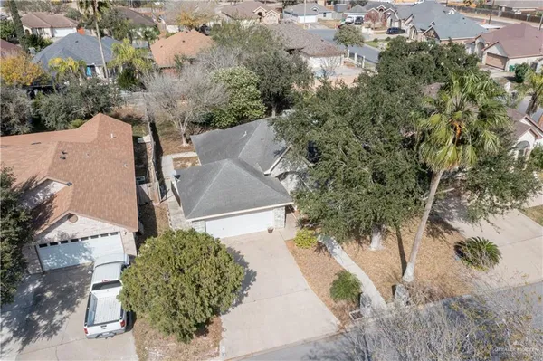an aerial view of a house with yard