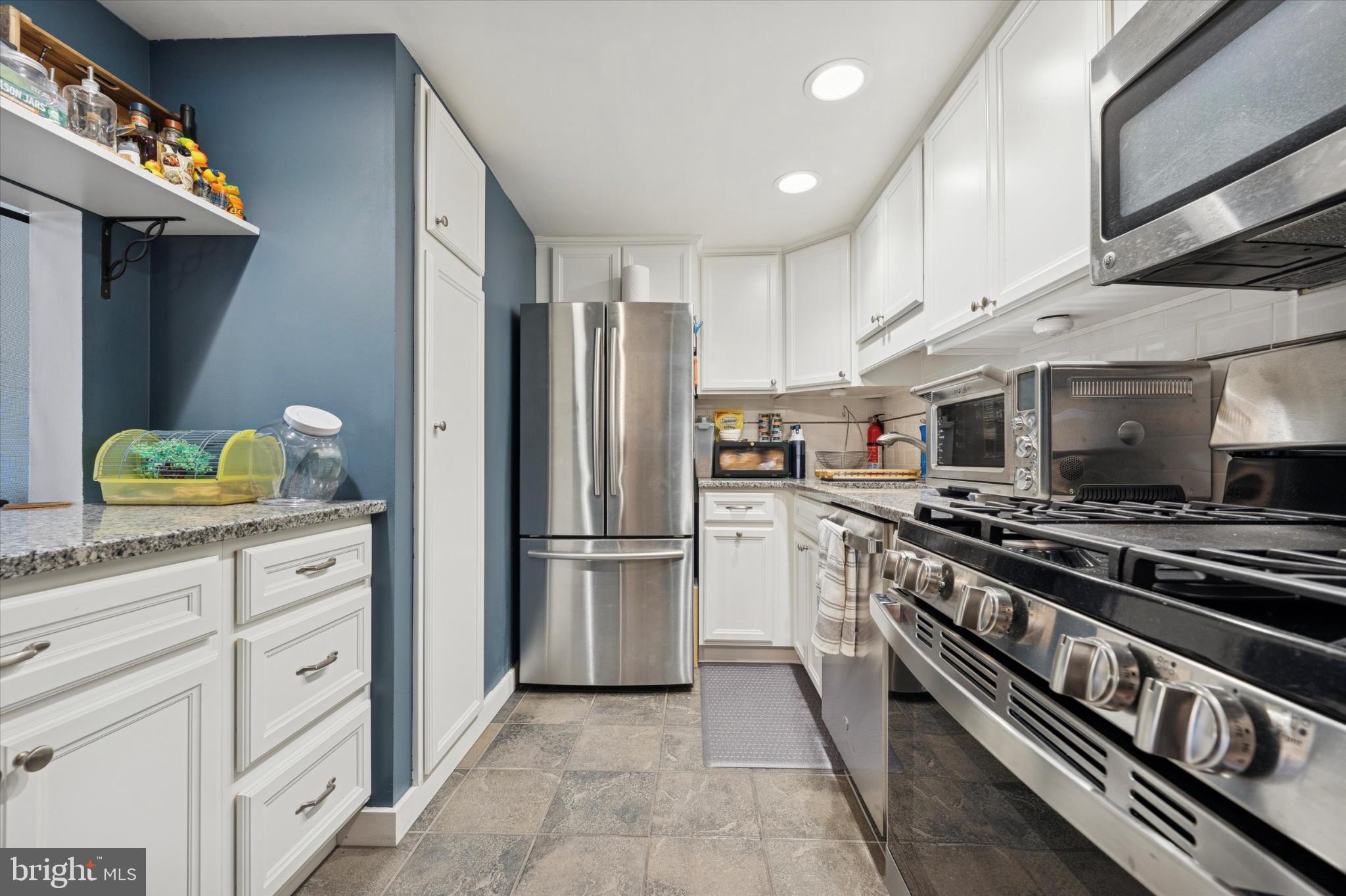 275 Old Forge Crossing Devon, PA 19333 - Photo 2 of 17 a kitchen with stainless steel appliances and white cabinets