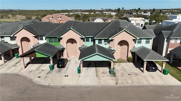 an aerial view of a house with a yard
