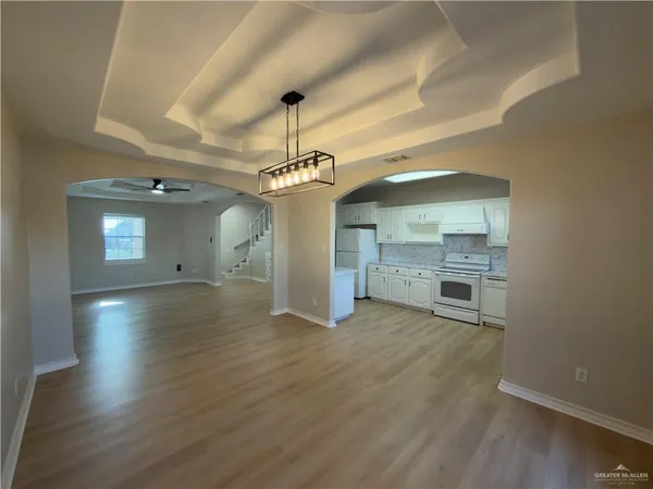 a kitchen with granite countertop white cabinets and white appliances