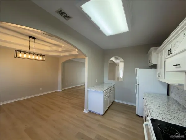 a view of hallway with stairs and wooden floor