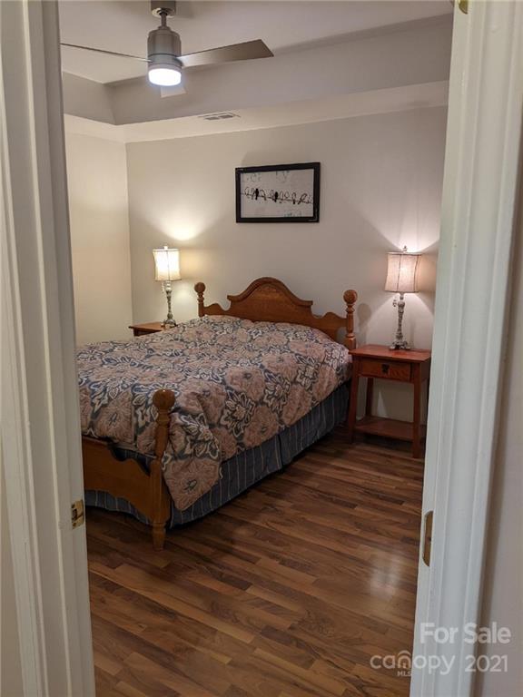 5030 Gibbons Link Road Charlotte, NC 28269 - Photo 11 of 28 a bedroom with a bed and a lamp