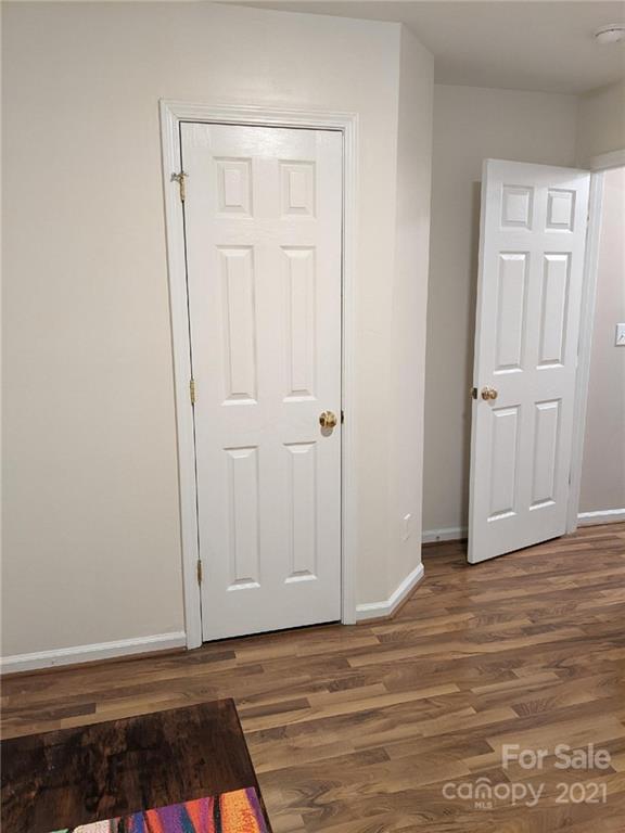 5030 Gibbons Link Road Charlotte, NC 28269 - Photo 12 of 28 a view of an empty room with wooden floor and closet