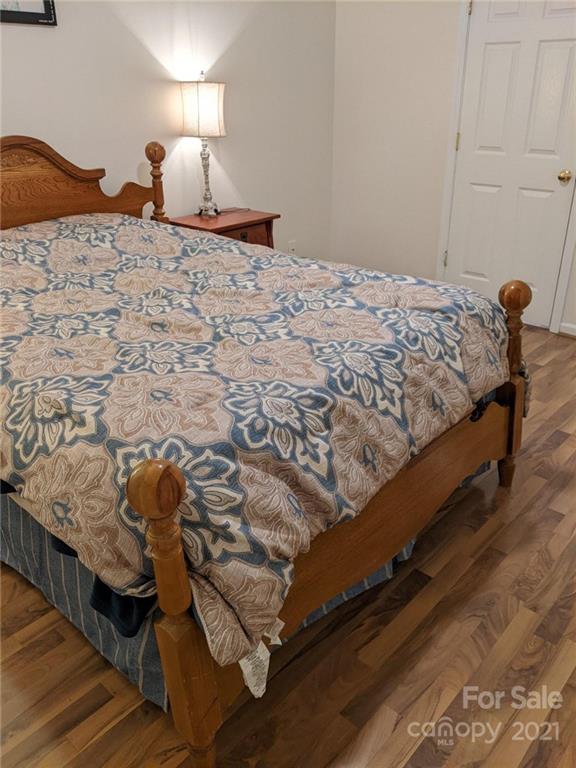 5030 Gibbons Link Road Charlotte, NC 28269 - Photo 18 of 28 a bed sitting in a bedroom next to a lamp
