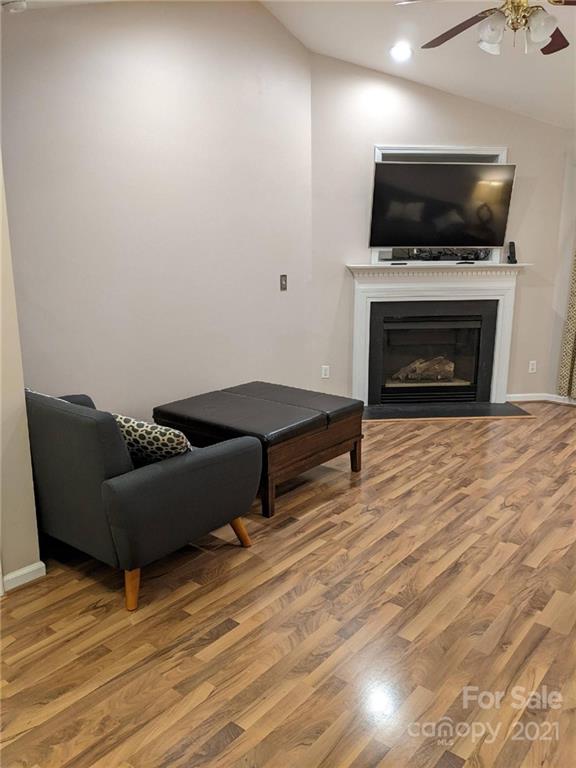 5030 Gibbons Link Road Charlotte, NC 28269 - Photo 3 of 28 a living room with furniture a flat screen tv and a fireplace