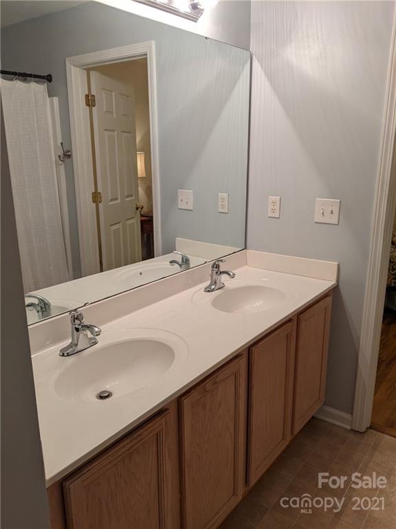 5030 Gibbons Link Road Charlotte, NC 28269 - Photo 28 of 28 a bathroom with a sink vanity and a mirror