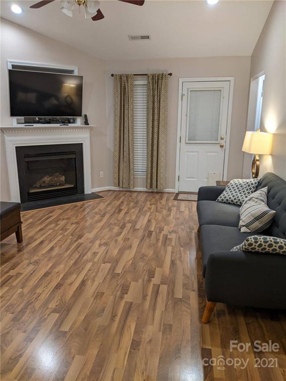 5030 Gibbons Link Road Charlotte, NC 28269 - Photo 4 of 28 a living room with furniture a flat screen tv and a fireplace