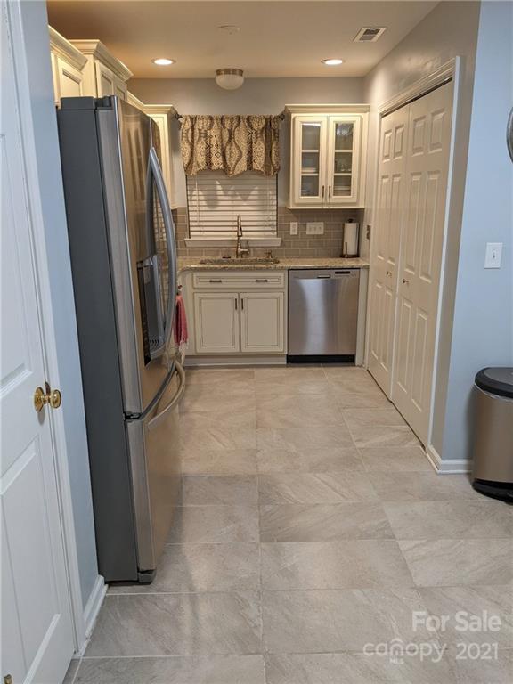 5030 Gibbons Link Road Charlotte, NC 28269 - Photo 6 of 28 a kitchen with stainless steel appliances a refrigerator sink and cabinets