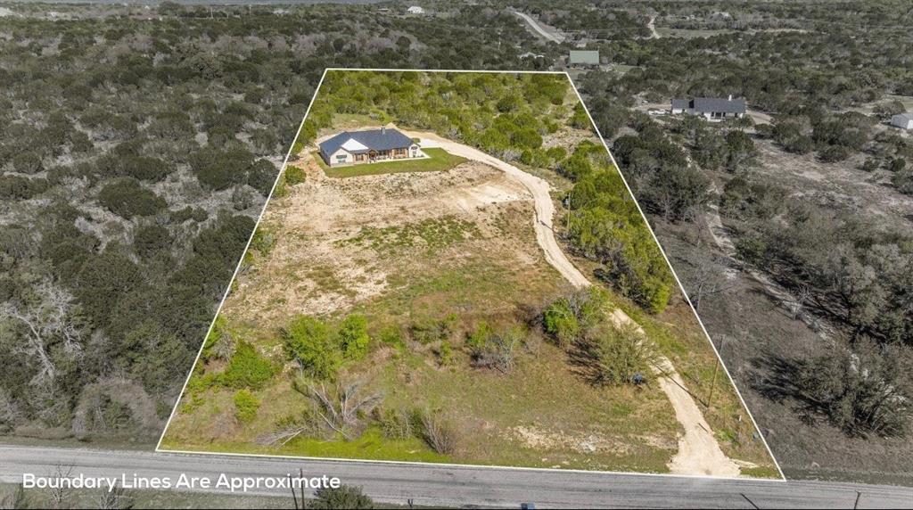 2455 Schooner Way Bluff Dale, TX 76433 - Photo 32 of 37 Aerial overview of property's location featuring property parcel outlined and a heavily wooded area