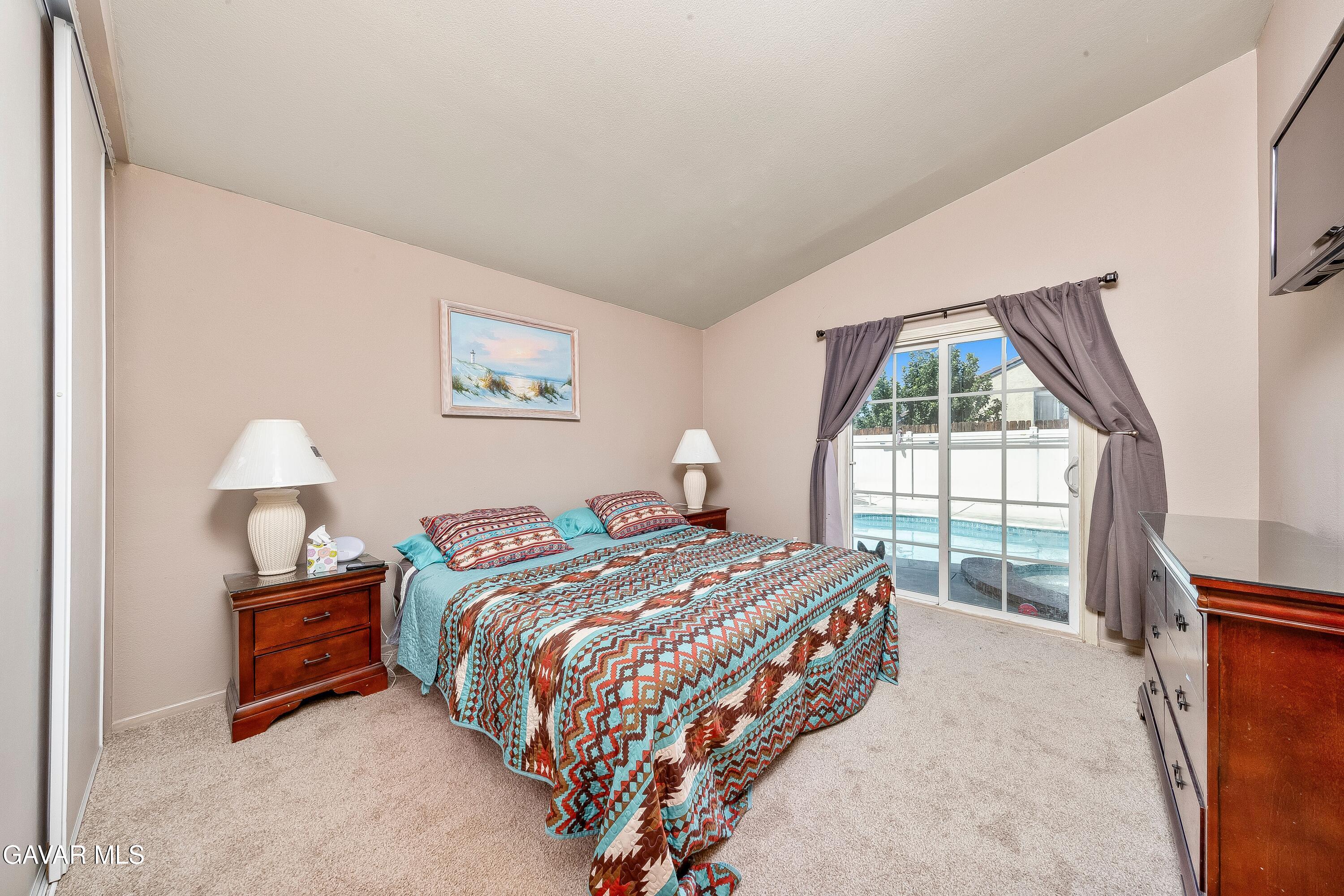 5767 East Ave R 11 Palmdale, CA 93552 - Photo 12 of 27 a bedroom with a bed and a window