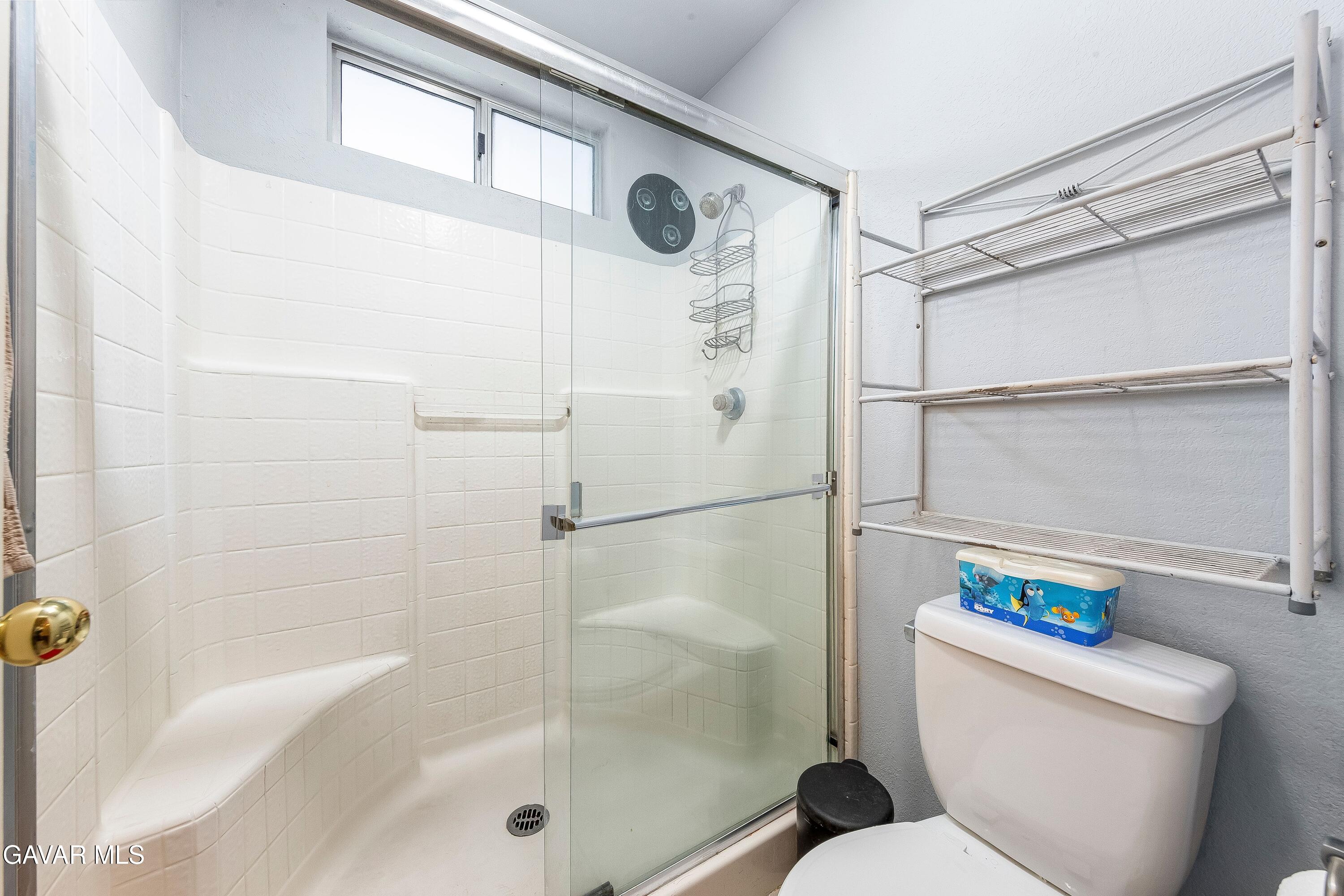 5767 East Ave R 11 Palmdale, CA 93552 - Photo 14 of 27 a bathroom with a shower and a toilet