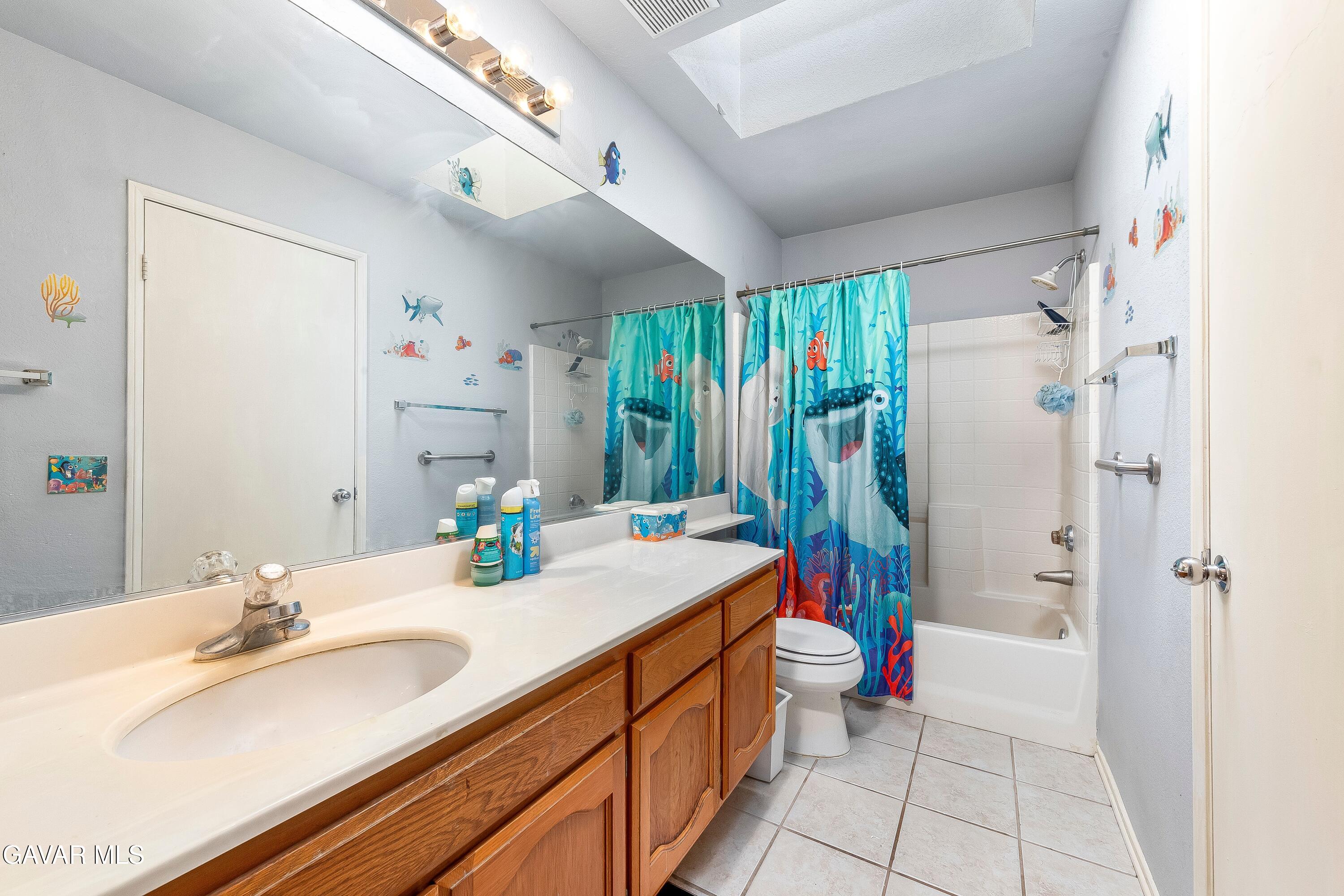 5767 East Ave R 11 Palmdale, CA 93552 - Photo 16 of 27 a bathroom with a sink a toilet and shower