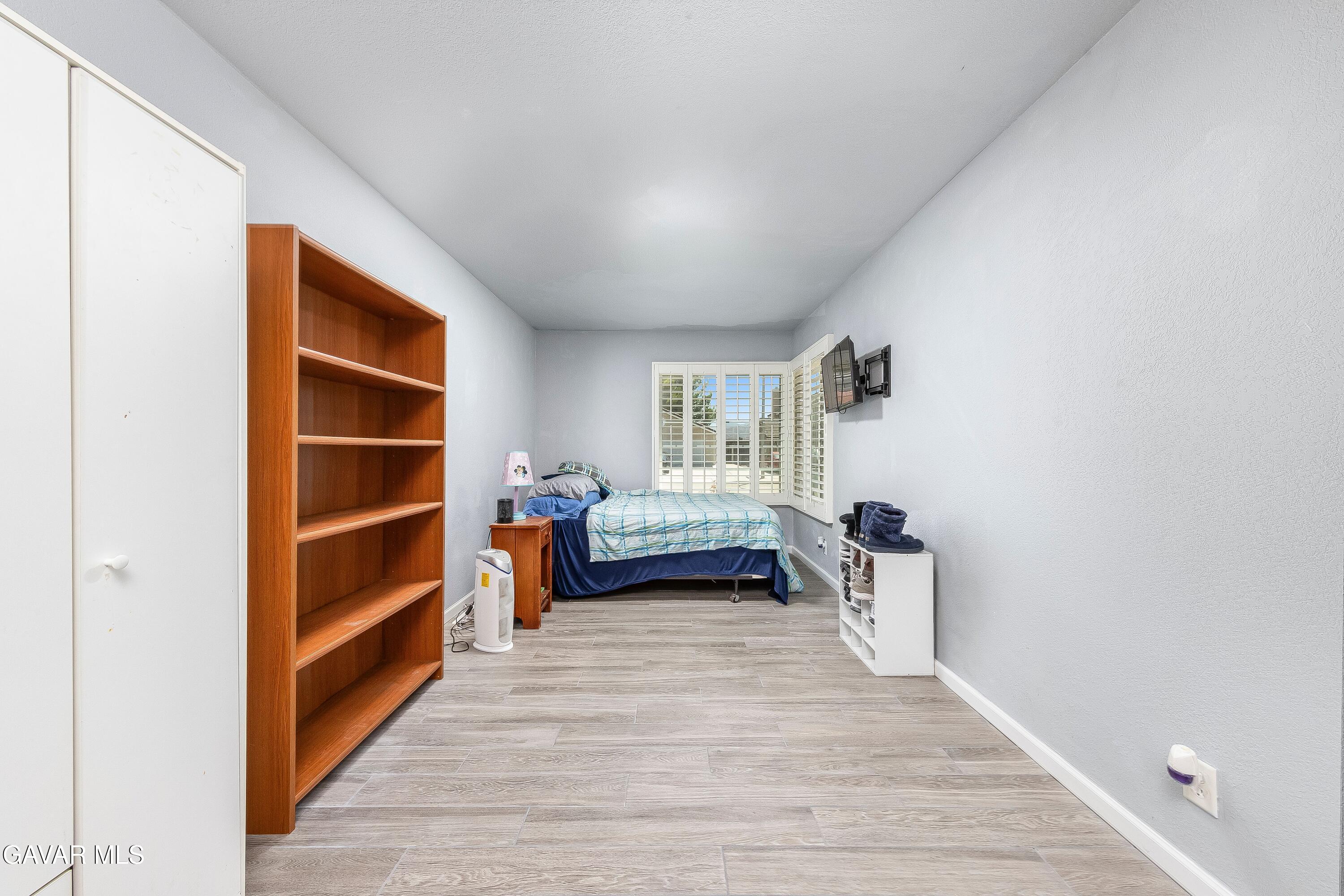 5767 East Ave R 11 Palmdale, CA 93552 - Photo 17 of 27 a view of empty room with wooden floor and window