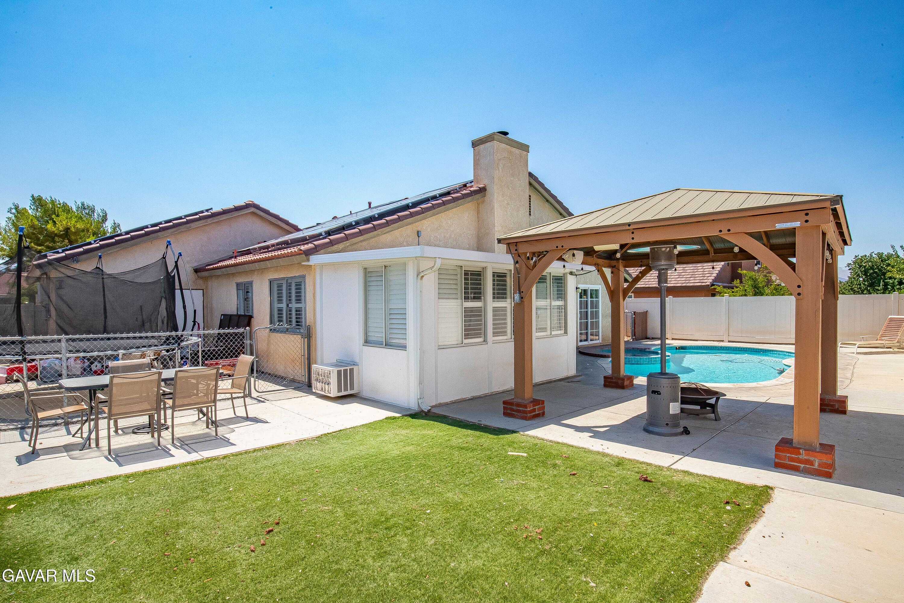 5767 East Ave R 11 Palmdale, CA 93552 - Photo 21 of 27 a view of a house with backyard sitting area and garden