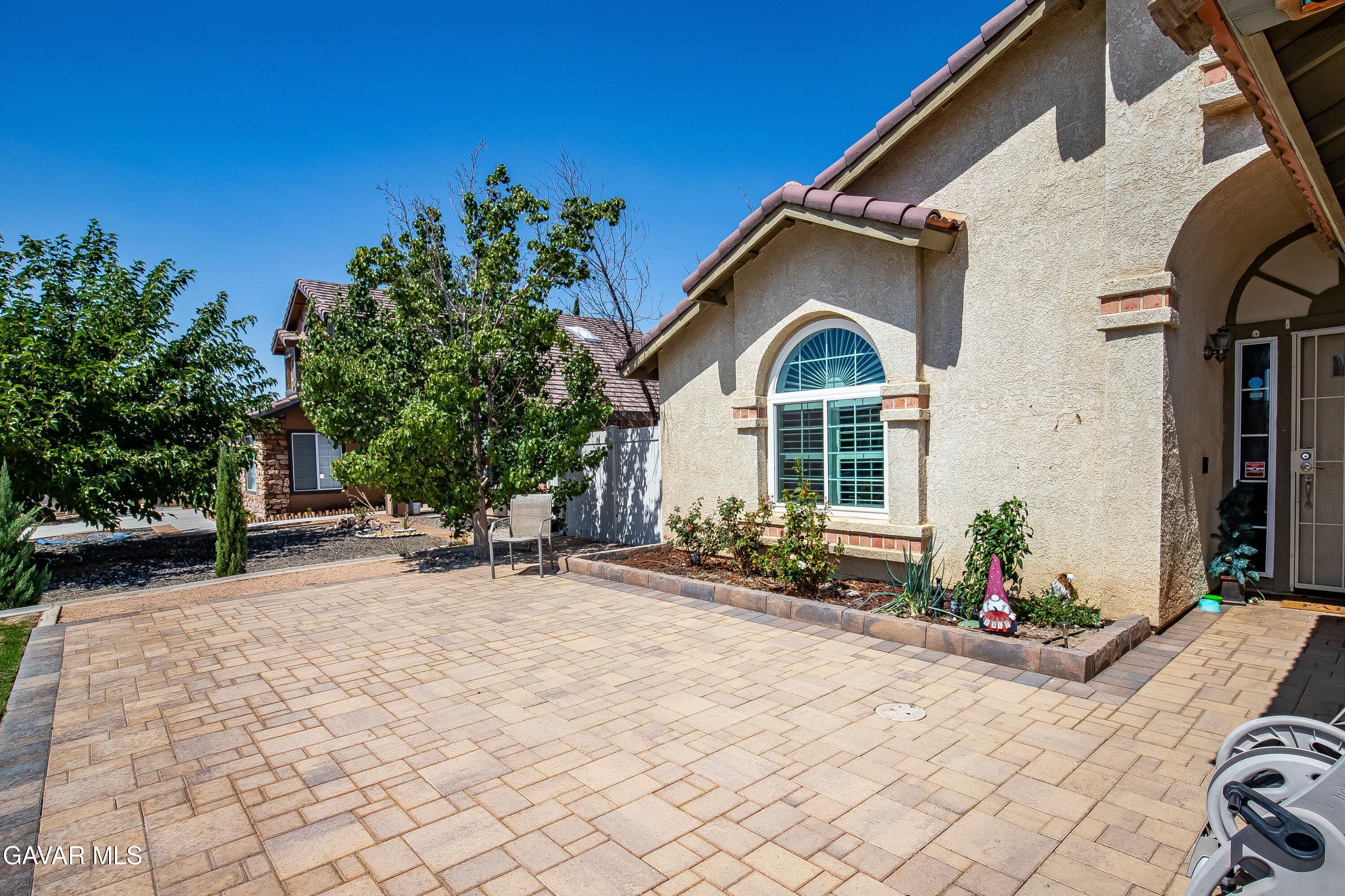 5767 East Ave R 11 Palmdale, CA 93552 - Photo 3 of 27 a front view of a house with a yard