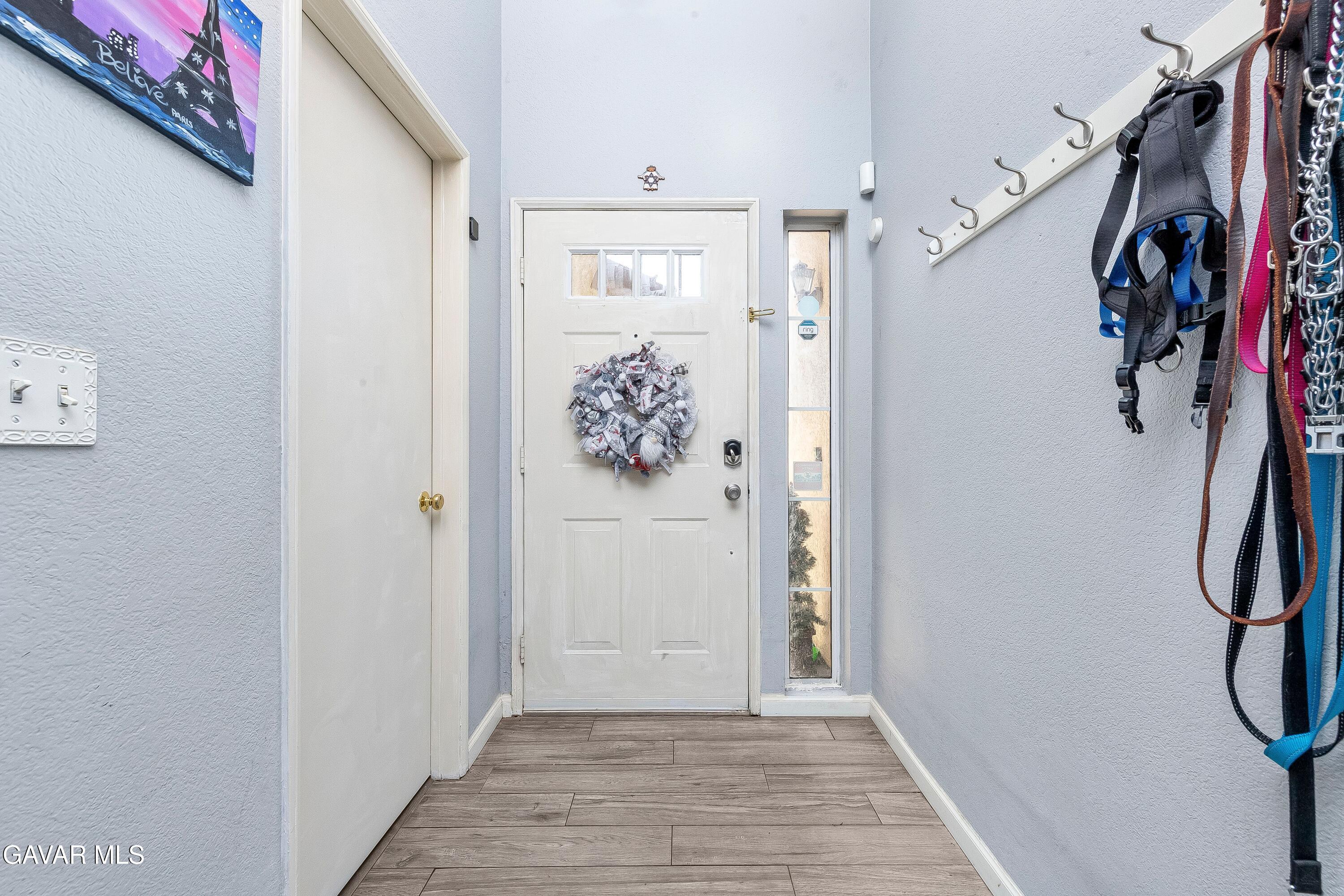 5767 East Ave R 11 Palmdale, CA 93552 - Photo 6 of 27 a view of a hallway with wooden floor and closet