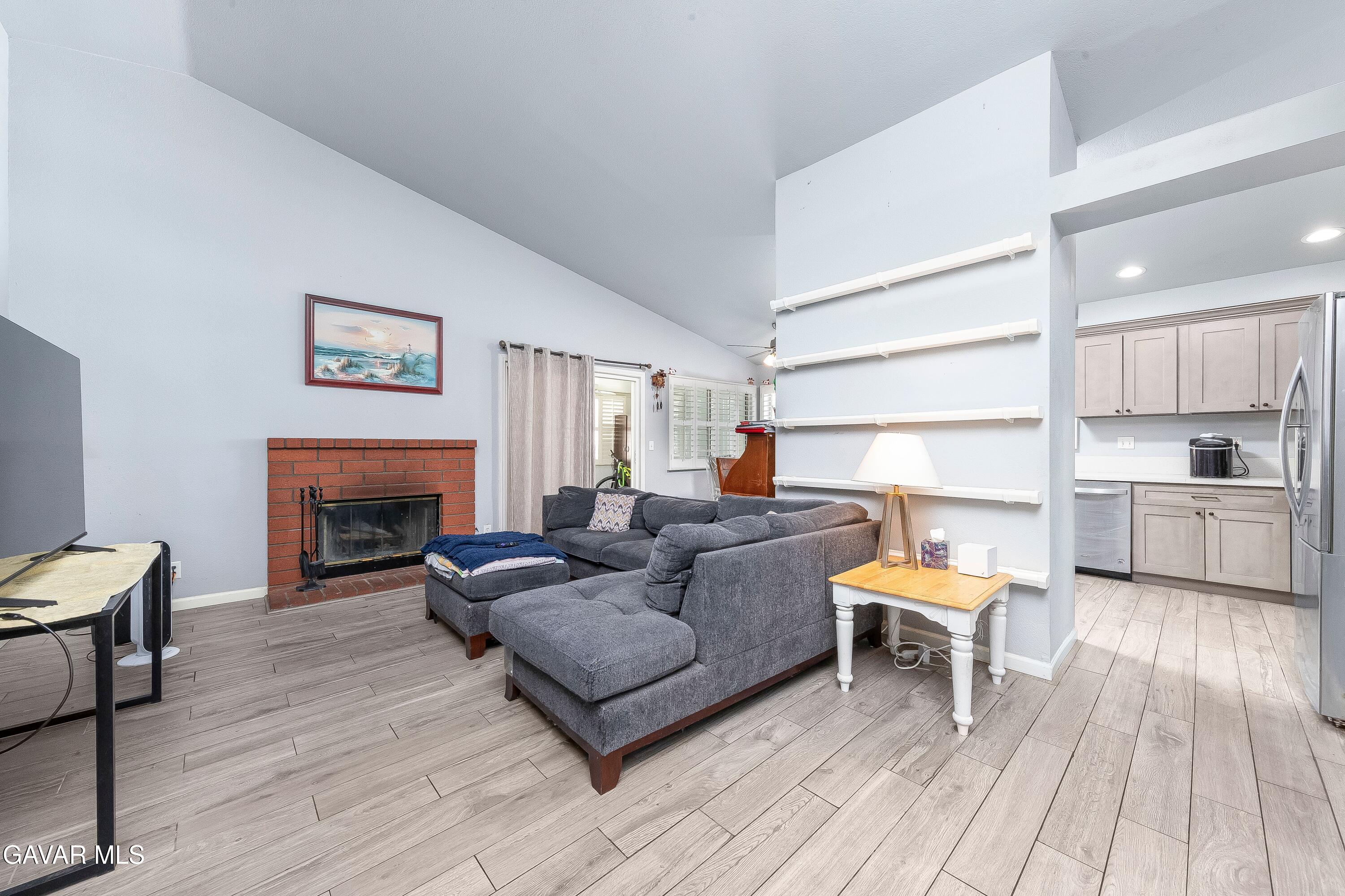 5767 East Ave R 11 Palmdale, CA 93552 - Photo 7 of 27 a living room with furniture and a fireplace