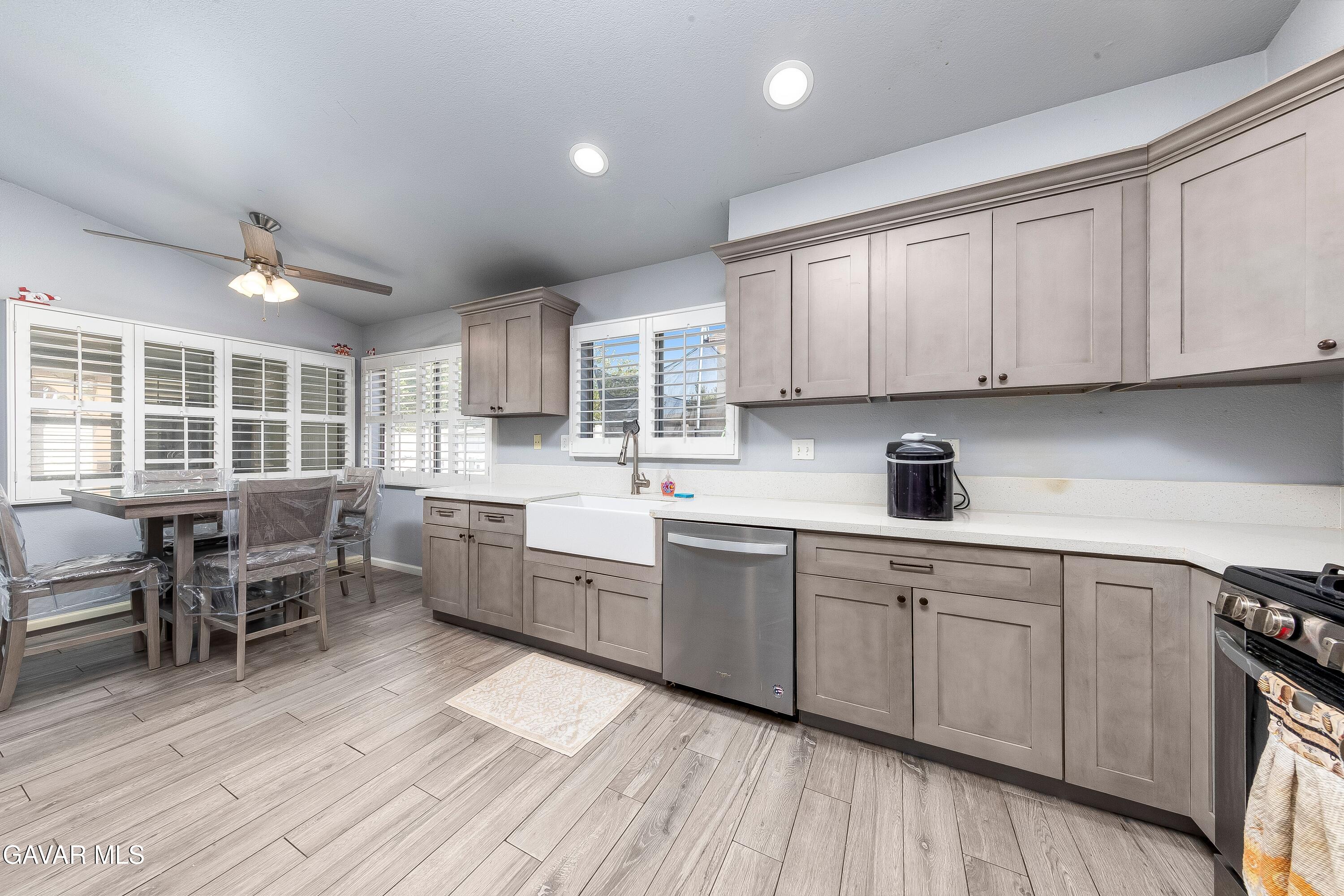 5767 East Ave R 11 Palmdale, CA 93552 - Photo 8 of 27 a kitchen with sink cabinets and wooden floor