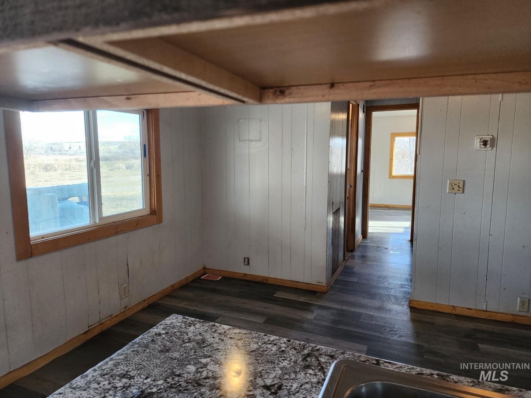 1853 McLay Road Vale, OR 97918 - Photo 3 of 8 Unfurnished room featuring wood walls and dark wood-style floors
