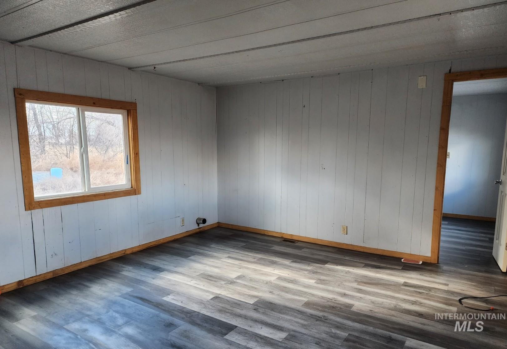 1853 McLay Road Vale, OR 97918 - Photo 4 of 8 Unfurnished room with light wood finished floors and wood walls