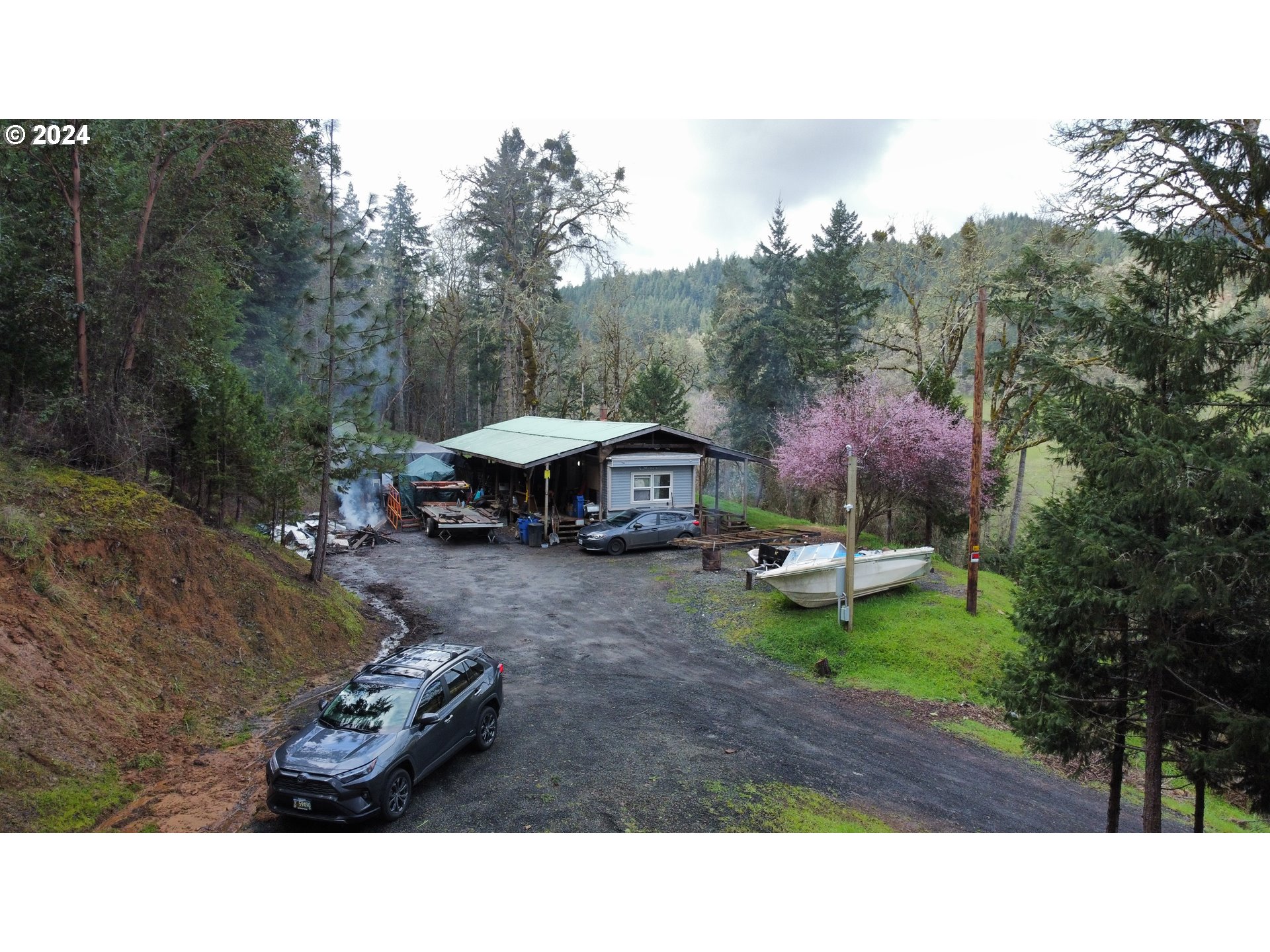 326 Rice Creek Road Winston, OR 97496 - Photo 1 of 22 a backyard of a house with table and chairs