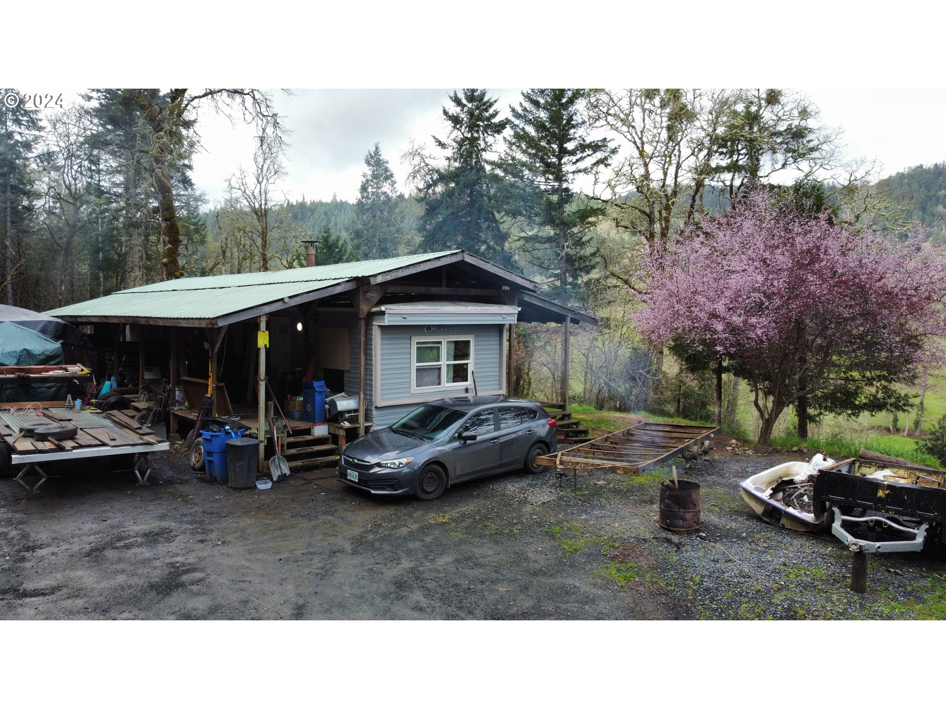 326 Rice Creek Road Winston, OR 97496 - Photo 2 of 22 a backyard of a house with fire pit and outdoor seating