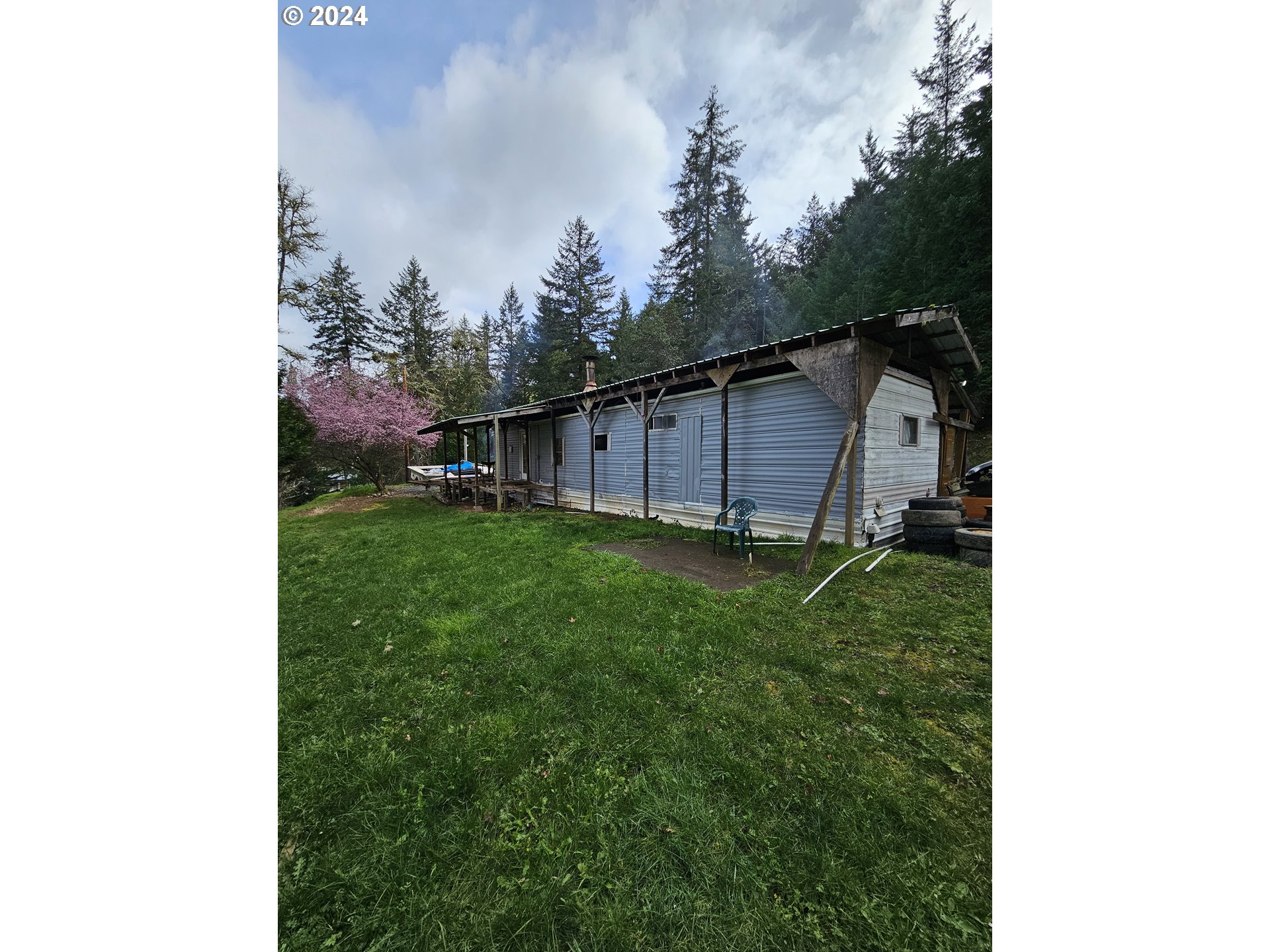 326 Rice Creek Road Winston, OR 97496 - Photo 3 of 22 a backyard of a house with lots of green space