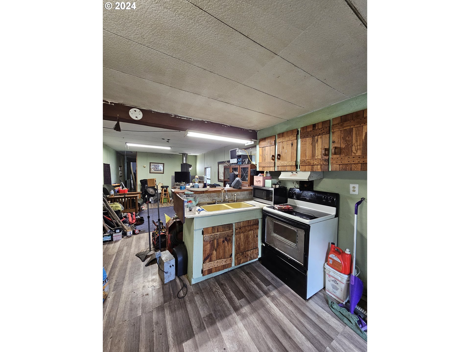 326 Rice Creek Road Winston, OR 97496 - Photo 10 of 22 a kitchen with stainless steel appliances granite countertop a stove and a refrigerator