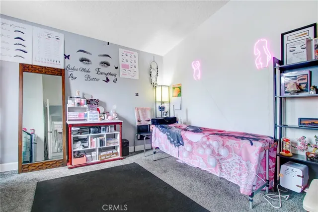 a bedroom with bed and dresser