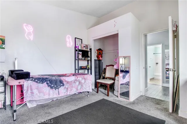 a bedroom with furniture and a lamp