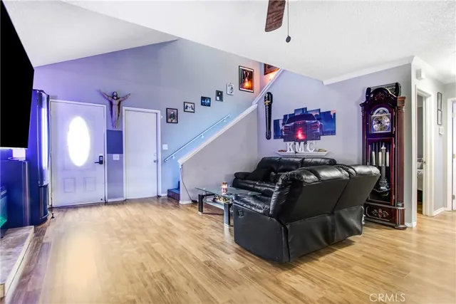 a living room with furniture and wooden floor