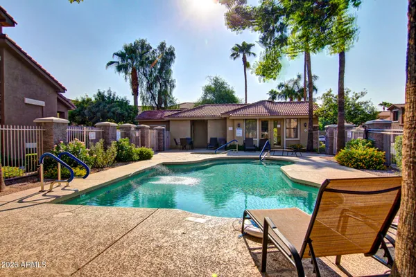 a view of a chairs and table in patio with a lake view