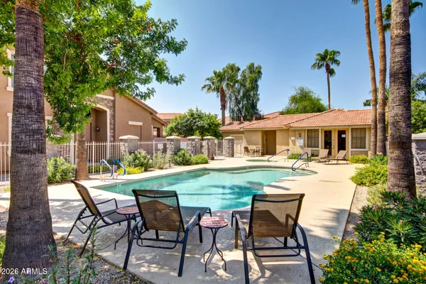 a view of a patio with table and chairs potted plants with palm tree