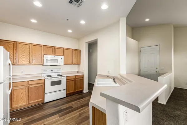 a kitchen with a refrigerator and a stove