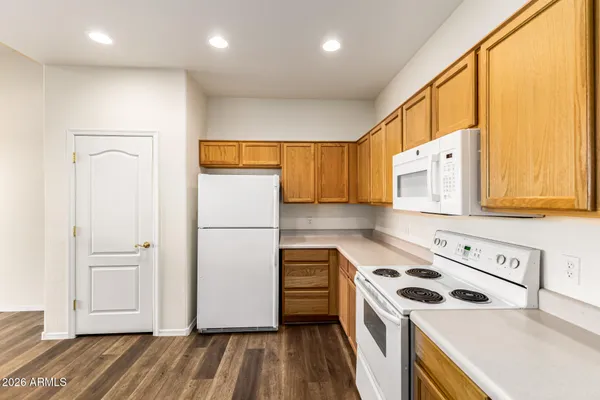 a kitchen with stainless steel appliances granite countertop a refrigerator and a stove top oven