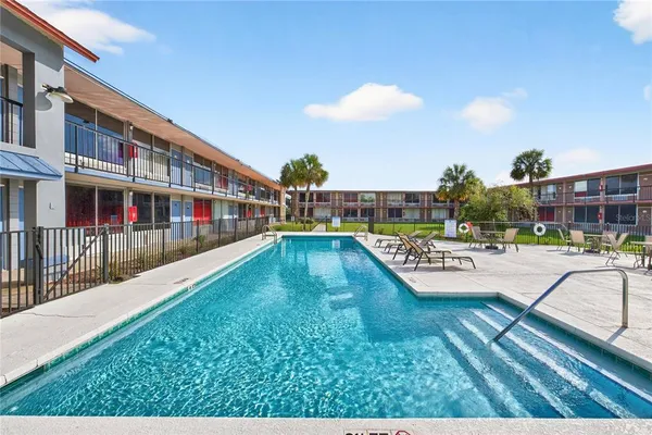 a view of a swimming pool with a lounge chairs