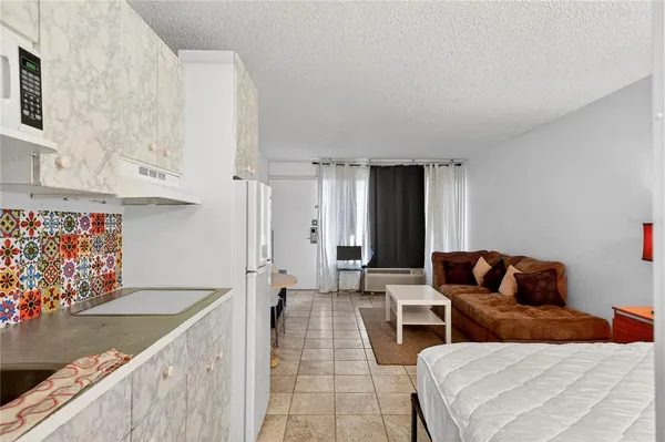 a living room with furniture and painting on the wall