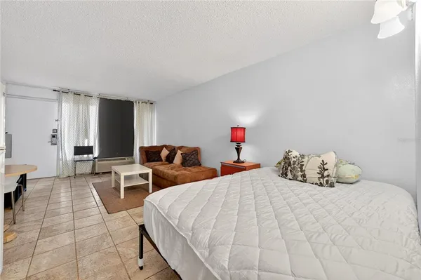 a bedroom with two beds and a chandelier
