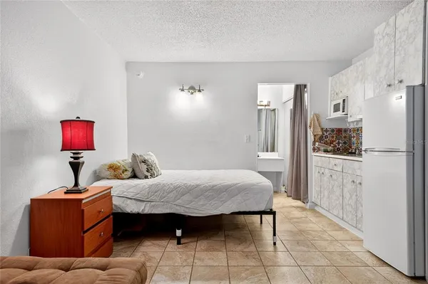 a room with furniture a mirror a lamp and entryway