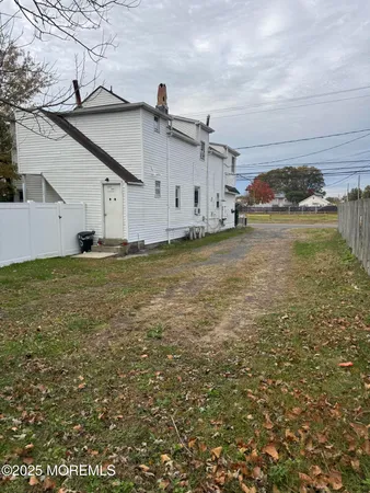 a big house with a big yard and large trees