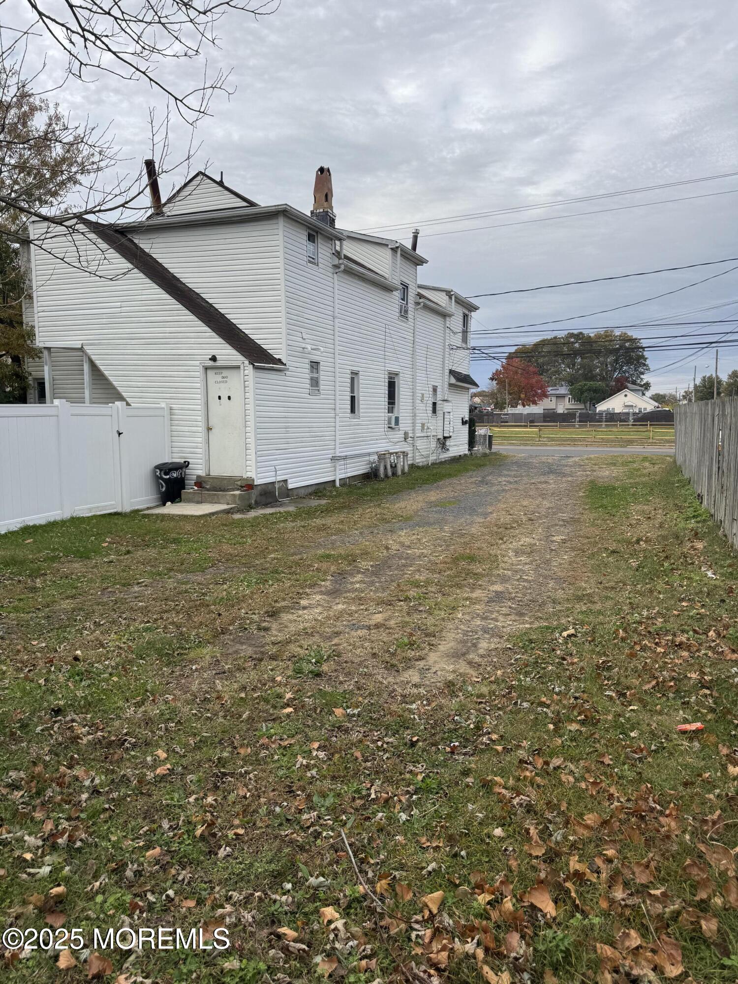 172 Carr Avenue, Unit D Keansburg, NJ 07734 - Photo 11 of 12 a big house with a big yard and large trees