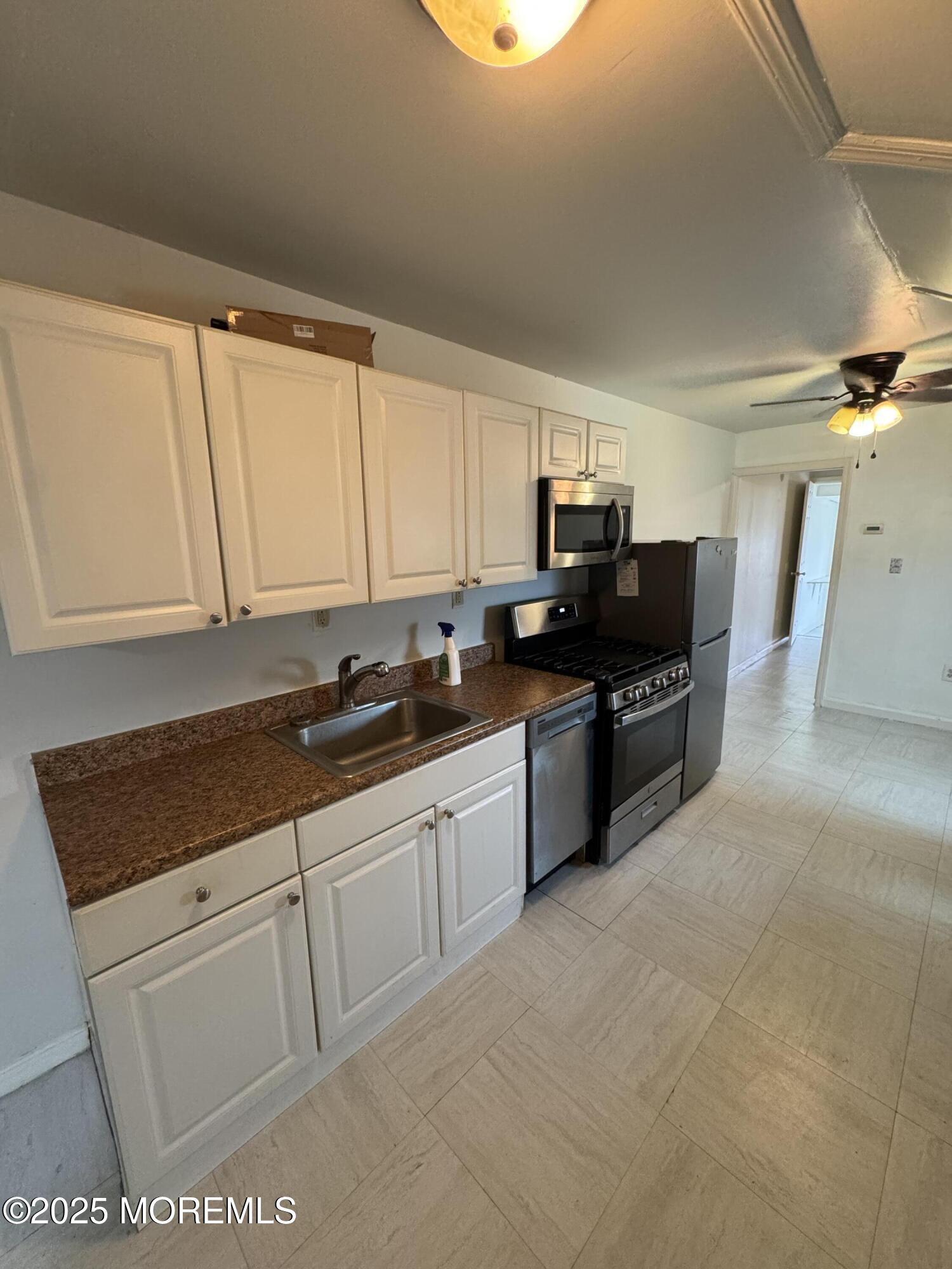 172 Carr Avenue, Unit D Keansburg, NJ 07734 - Photo 2 of 12 a large kitchen with granite countertop a sink and a stove