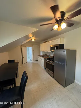 a kitchen with stainless steel appliances granite countertop a refrigerator and a stove top oven